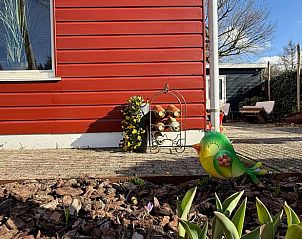 Colorful garden ornaments at Holiday home in Voorthuizen, Veluwe, with flowers and decorations.