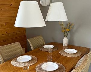 Cozy dining area in the Cottage in Voorthuizen, Veluwe, with wooden table and atmospheric lighting for a relaxing stay.