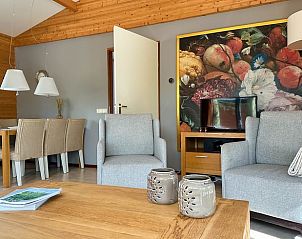 Stylish sitting area in Holiday Home in Voorthuizen, Veluwe, with art on the wall.