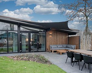 Enjoy the modern veranda of Top-Nova Scotia vacation home in Voorthuizen, Veluwe. Perfect for relaxation in the nature of Gelderland.