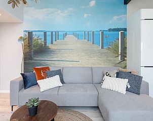 Stylish living room of Top-Nova Scotia vacation home in Voorthuizen, Veluwe, Gelderland with an atmospheric view of a waterfront pier.