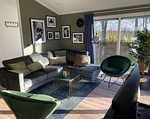 Comfortabele zithoek in Vakantiehuis Hackfort 6, Hulshorst, Veluwe met uitzicht op de natuur.