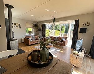 Cozy living room of Holiday Home in Epe, Veluwe, Gelderland with stylish decor and views of the green garden.