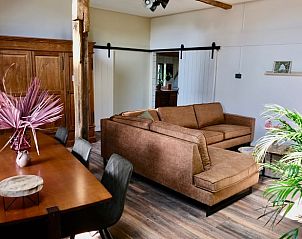 Cozy living room in Holiday Home in Epe, Veluwe, Gelderland with comfortable sofa and wooden interior.