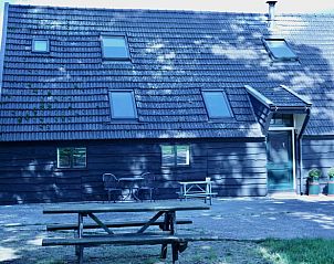 Terrace with picnic table at cottage in Epe, Veluwe, Gelderland overlooking nature.