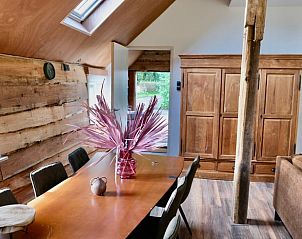 Wooden interior of Holiday cottage in Epe, Veluwe, Gelderland with spacious dining room and natural light.
