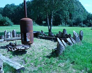 Unique outdoor space at Holiday Home in Epe, Veluwe, Gelderland with fire pit and logs.