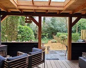 Enjoy the peace and quiet on the veranda of Holiday Home in Epe, Veluwe, Gelderland, overlooking the green garden and surrounding nature.