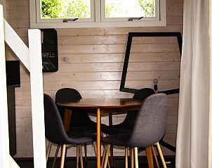 Cozy indoor area of Holiday Home in Epe, Veluwe, Gelderland, with wooden walls and modern dining set for a relaxing stay.