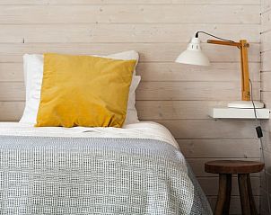 Cozy bedroom in Holiday home in Epe, Veluwe. Comfortable bed with wooden wall decor and atmospheric lighting in Gelderland.