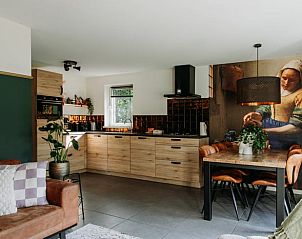 Stylish kitchen in Holiday Home in Nunspeet, Veluwe, with modern appliances and cozy dining area.
