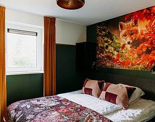 Attractive bedroom in Holiday Home in Nunspeet, Veluwe, with colorful accents and a large window.