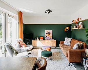 Bright living room in Cottage in Nunspeet, Veluwe, with modern furnishings and access to the terrace.