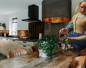 Spacious kitchen and dining room in Holiday cottage in Nunspeet, Veluwe, with modern appliances and cozy atmosphere.