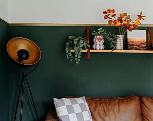 Stylish decoration in Holiday home in Nunspeet, Veluwe, with plants and artwork on the wall.