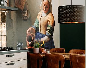 Cozy dining area in Holiday cottage in Nunspeet, Veluwe, with artistic mural and modern lighting.