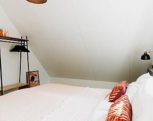 Bright bedroom in Cottage in Nunspeet, Veluwe, with modern furnishings and comfortable beds.