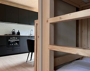 Modern kitchen and cozy sleeping area in Holiday home in Nunspeet, ideal for a stay in Veluwe, Gelderland.