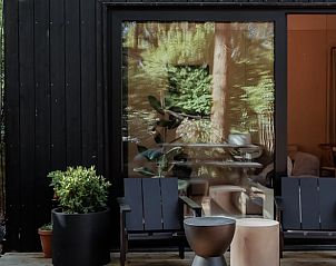 Terrace with seating at cottage in Nunspeet, tucked away in the Veluwe woods.