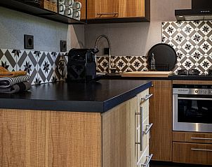 Modern kitchen in Holiday home in Nunspeet, Veluwe with stylish tiles and appliances.