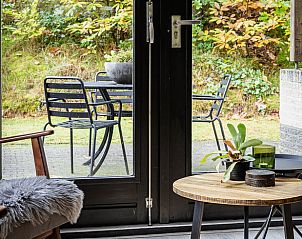 Cozy sitting area overlooking garden at Holiday home in Nunspeet on the Veluwe.