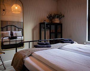 Comfortable bedroom in Holiday home in Nunspeet, Veluwe, with large windows.