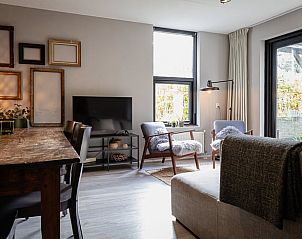 Stylish living room in Holiday Home in Nunspeet, Veluwe, with modern furnishings.