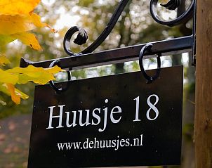 Welcome sign at Holiday home in Nunspeet, Veluwe, surrounded by autumn leaves.