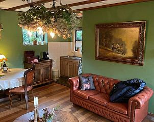 Cozy living room in Holiday Home in Lunteren, Veluwe, Gelderland with rustic furnishings and comfortable leather sofa.
