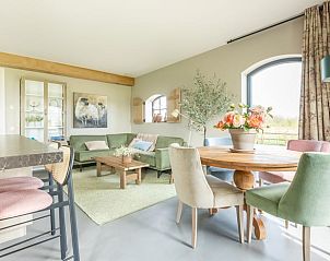 Cozy living room of Holiday Home in Lunteren, Veluwe, with comfortable seating and dining area, ideal for relaxation in Gelderland.