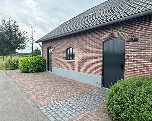 Vacation home in Lunteren, a charming vacation home in the Veluwe, Gelderland, with an inviting brick facade and rural setting.