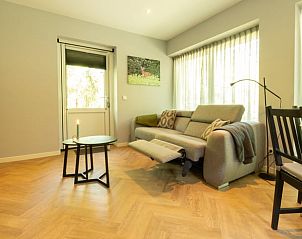 Comfortable sitting area in Holiday Home in Lunteren, Veluwe, Gelderland with lots of natural light.