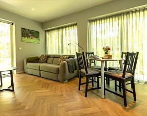 Bright living space in Holiday home in Lunteren, Veluwe, Gelderland with dining and sitting area.