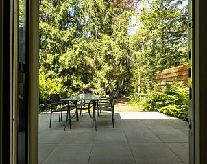 View from terrace of Holiday home in Lunteren, Veluwe, Gelderland on green surroundings.