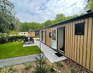 Vakantiehuisje in Lieren met ruime tuin en zitgedeelte, ideaal voor ontspanning op de Veluwe.