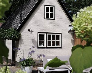 Vacation home in Ugchelen, Veluwe, Gelderland surrounded by flowers and rustic charm.