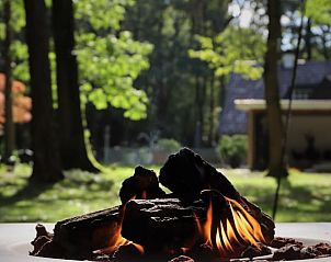 Cozy fire pit at Holiday home in Ugchelen, Veluwe, Gelderland overlooking the garden.