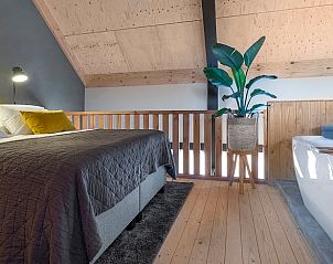 Luxe slaapkamer met bad in Vakantiehuis in Veessen, omgeven door de natuur van de Veluwe.