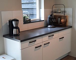 Keukenhoek in Robbenoort 121 Lauwersoog de Merel, vakantiehuis in Groningen met koffiezetapparaat en raam.