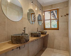 Moderne badkamer met stenen wastafels in Vakantiehuis in Bellingwolde.