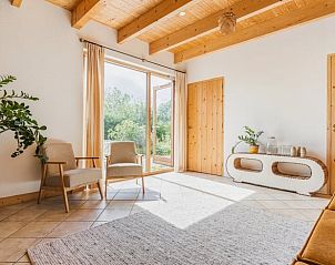 Lichte woonkamer met houten accenten in Vakantiehuis in Bellingwolde, Groningen.