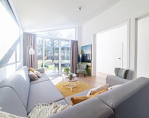 Gezellige woonkamer in de vakantiewoning in Sellingen met grote ramen in Zuidoost Groningen, Groningen.