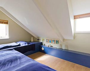 Slaapkamer met twee bedden in Vakantiehuisje in Haren, een gezellige ruimte in Zuidwest Groningen.