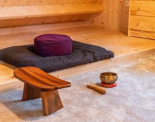 Meditatiehoek in Vakantiehuis in Noordlaren, Zuidwest Groningen, met kussen en houten vloer.