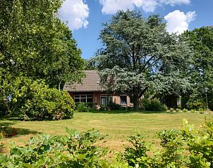 Huisje in Well, een vakantiehuis in Noord Limburg, omringd door weelderige natuur en rustgevende tuinen, ideaal voor een ontspannen verblijf.