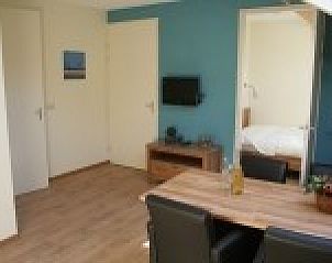 Modern living room in Apartment Green, Blue or Red in Horst, Limburg overlooking the bedroom.