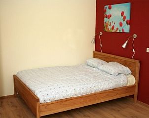 Comfortable bedroom in Apartment Green, Blue or Red in Horst, North Limburg with colorful accents.