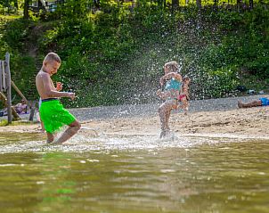 Kinderen spetteren in het water bij Vakantiehuis Cube Magnifique 10 in Belfeld, Noord Limburg voor vermaak.
