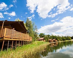 Enjoy the view from the veranda of Waterlodge in Maasbree, North Limburg, an idyllic waterfront vacation home for 8 people.