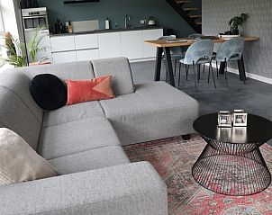 Stylish living room in Holiday Home in Baexem - Leudal, North Limburg with modern kitchen and comfortable seating area.